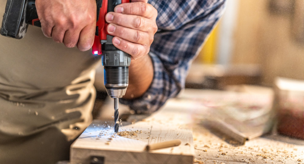 A DIY enthusiast is drilling wood with an electric drill，It is also the background image for the contact page, about us page, and blog page.